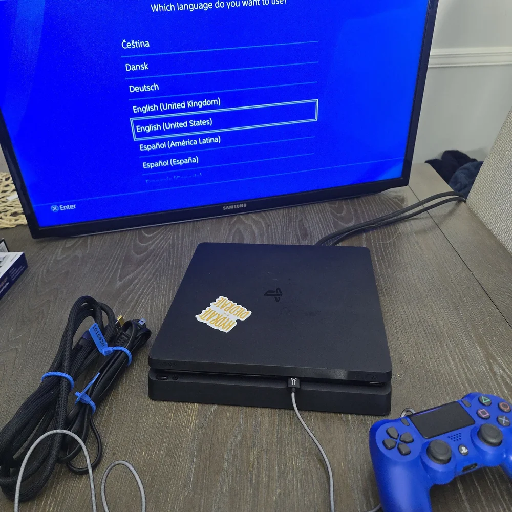 Sony PlayStation 4 Console with Black and Blue Controllers